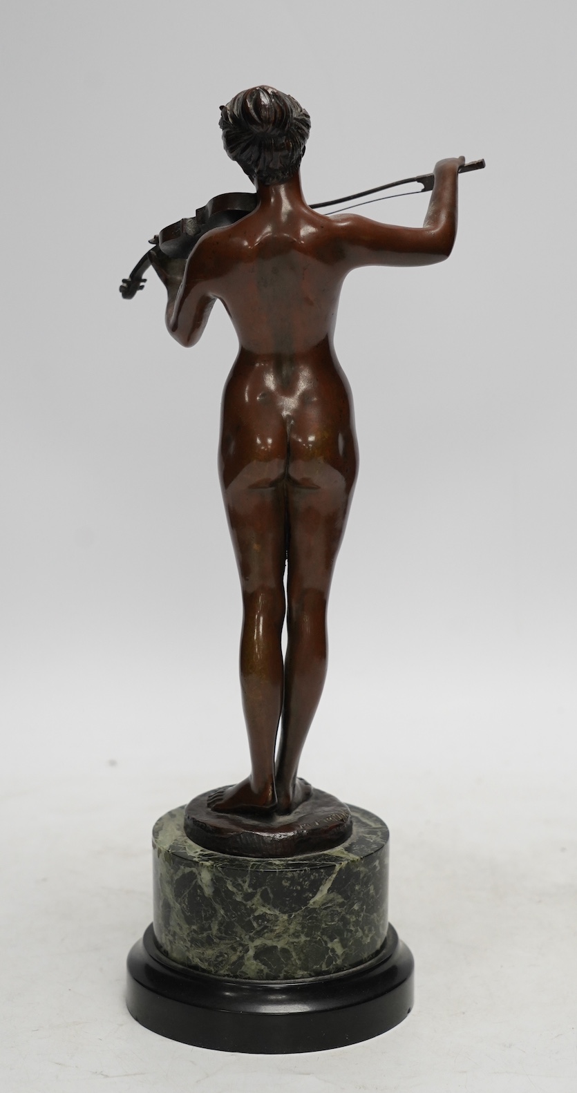 After Eugene Delaplanche (1836 - 1891), a brown patinated figure, La Musique, signed M. Matthias, on serpentine marble base, 31cm